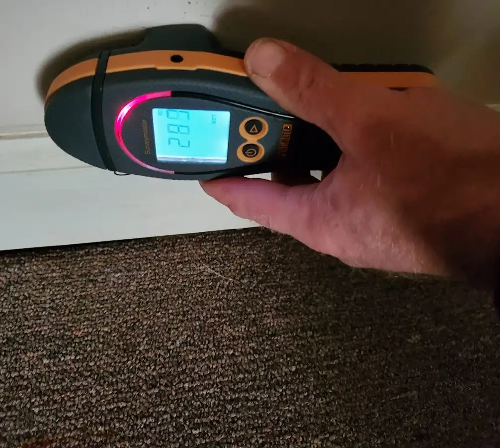 Moisture detection at baseboard during Storm Damage Restoration in Davenport